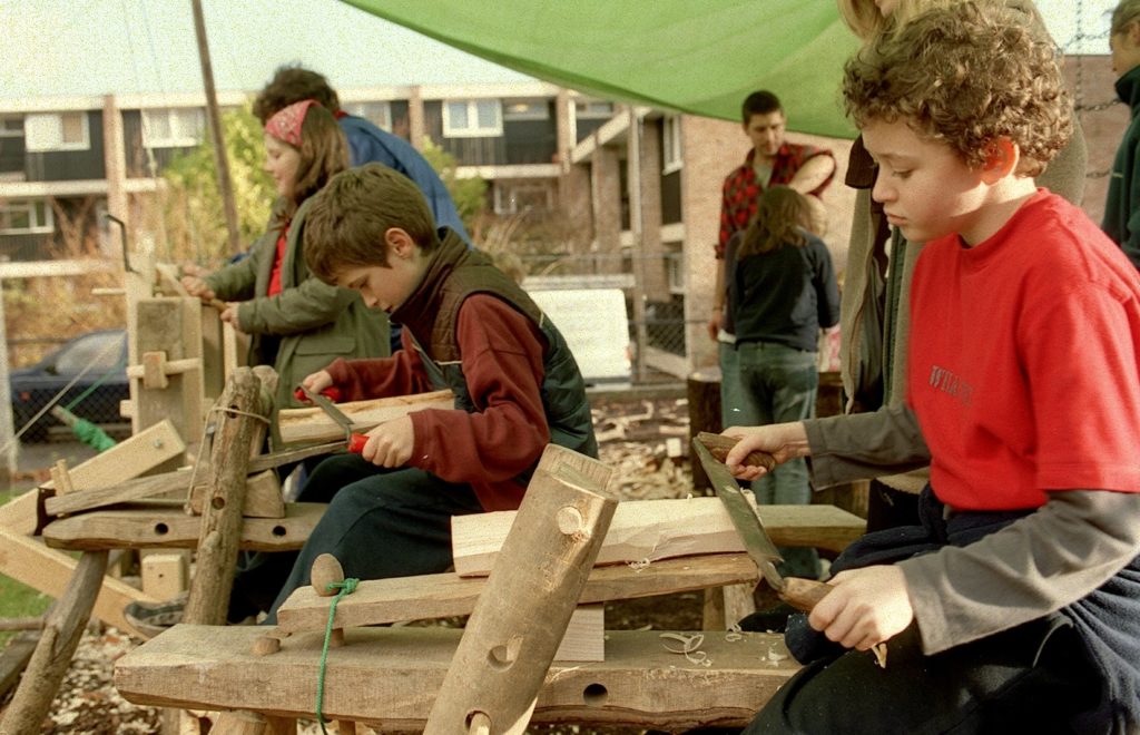 Colour photo of children taking part in playground project wood workshop at Hotwells Primary School in 2002