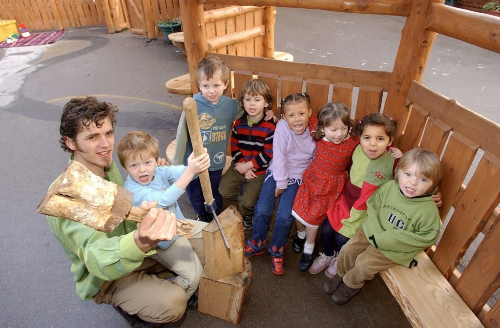 Colour photo of children taking part in playground project wood workshop at Hotwells Primary School in 2002