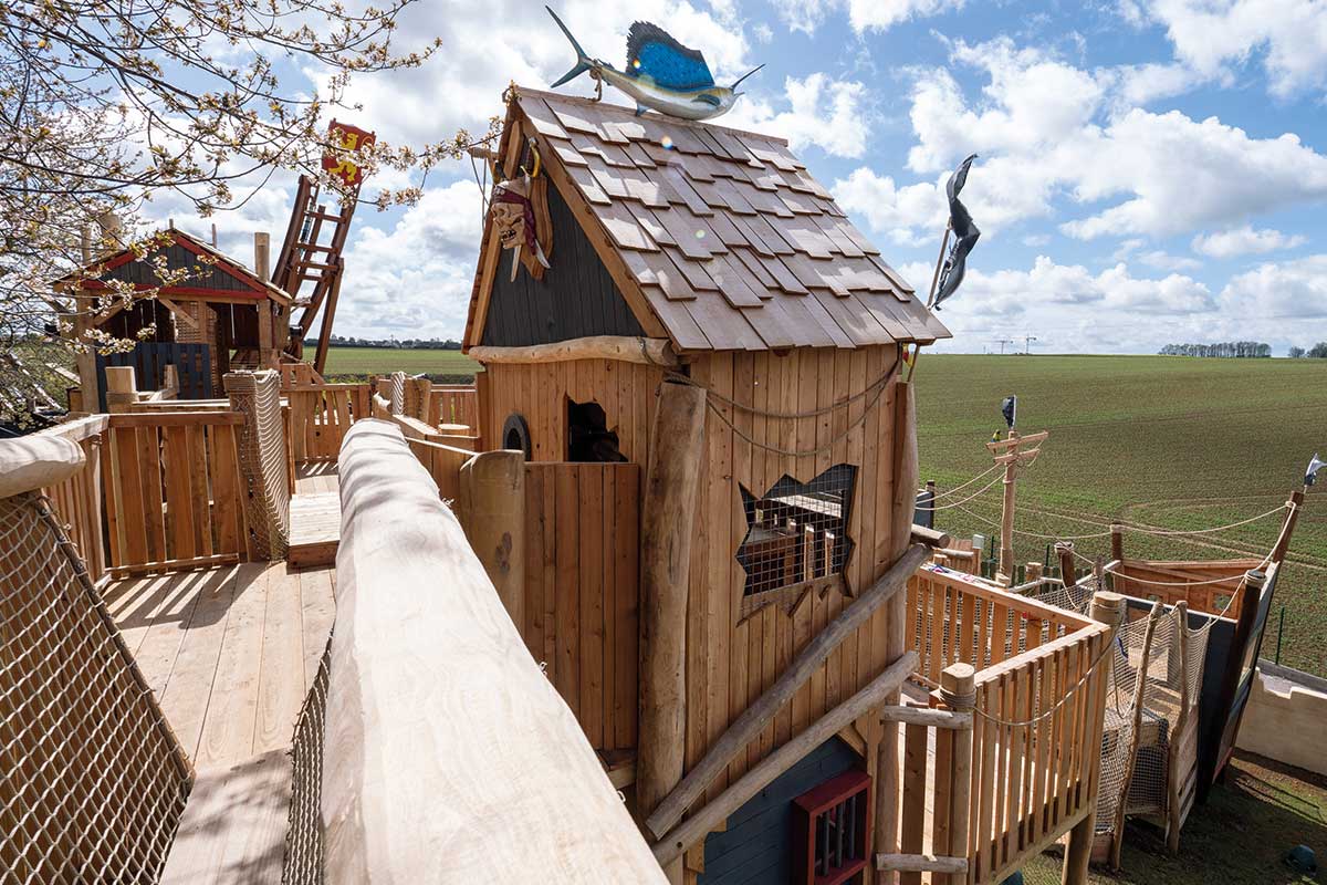 Colour photo of pirate-themed wooden playground tower with net bridges at Festyland theme park